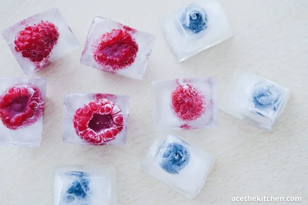 blueberry and raspberry in an icecube